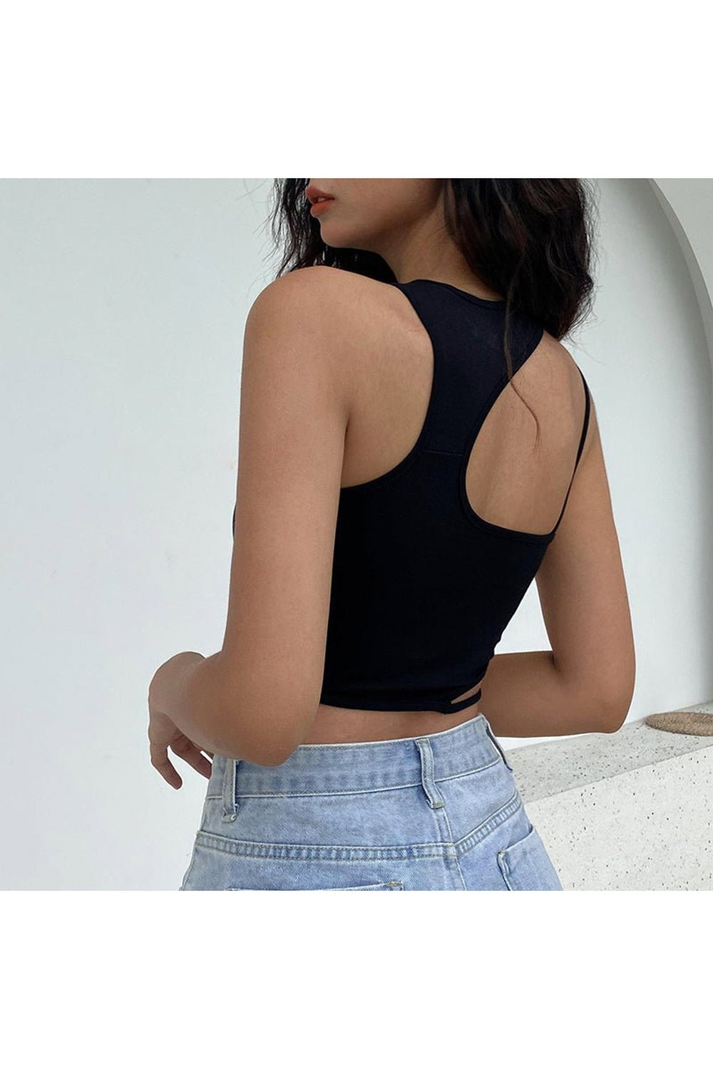 Stylish black crop top with intricate design.