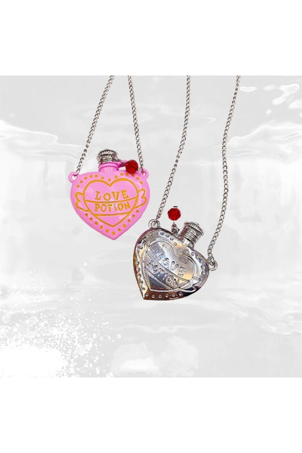 Pink necklace with silver pendant bottle charm.