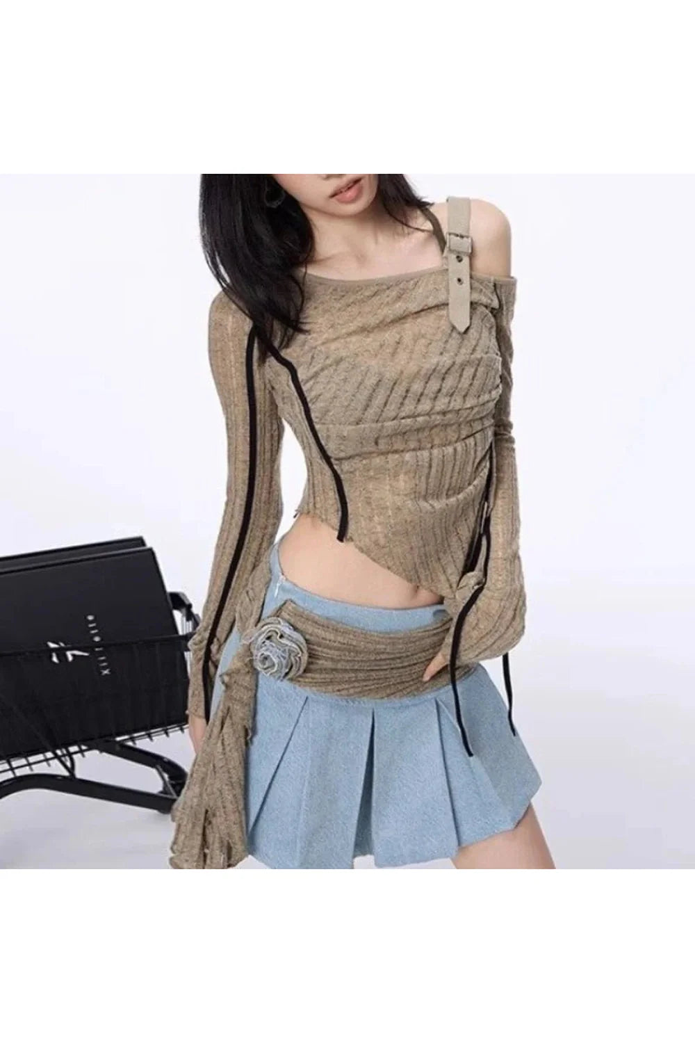 Stylish knit top with asymmetrical strap detail.