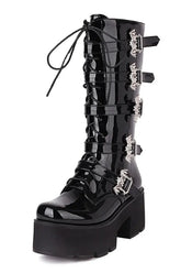 Gothic boots with bat buckle in shiny patent leather.