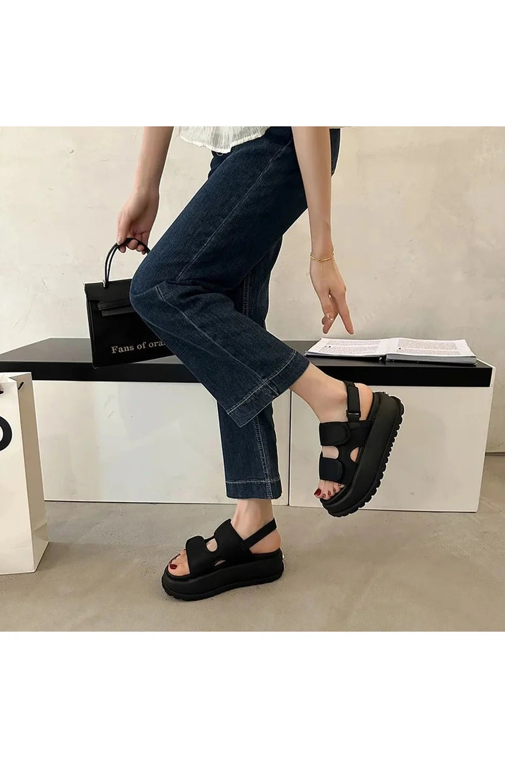 Chunky black Velcro strap sandals for casual wear.