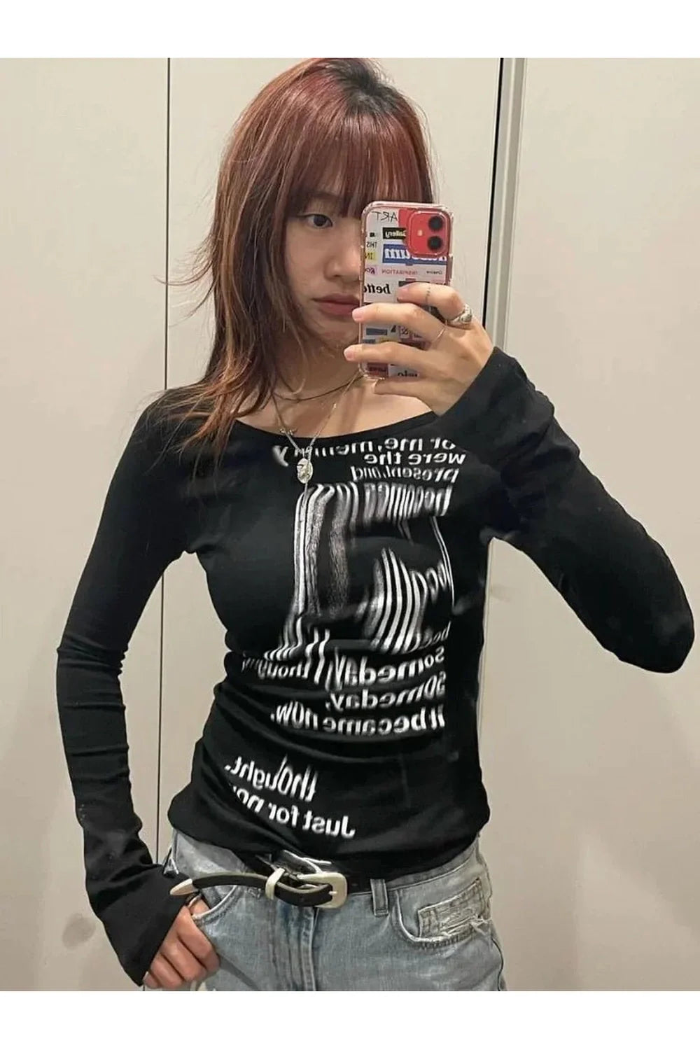 Black Distorted Text Print Long Sleeve Top with unique pattern.