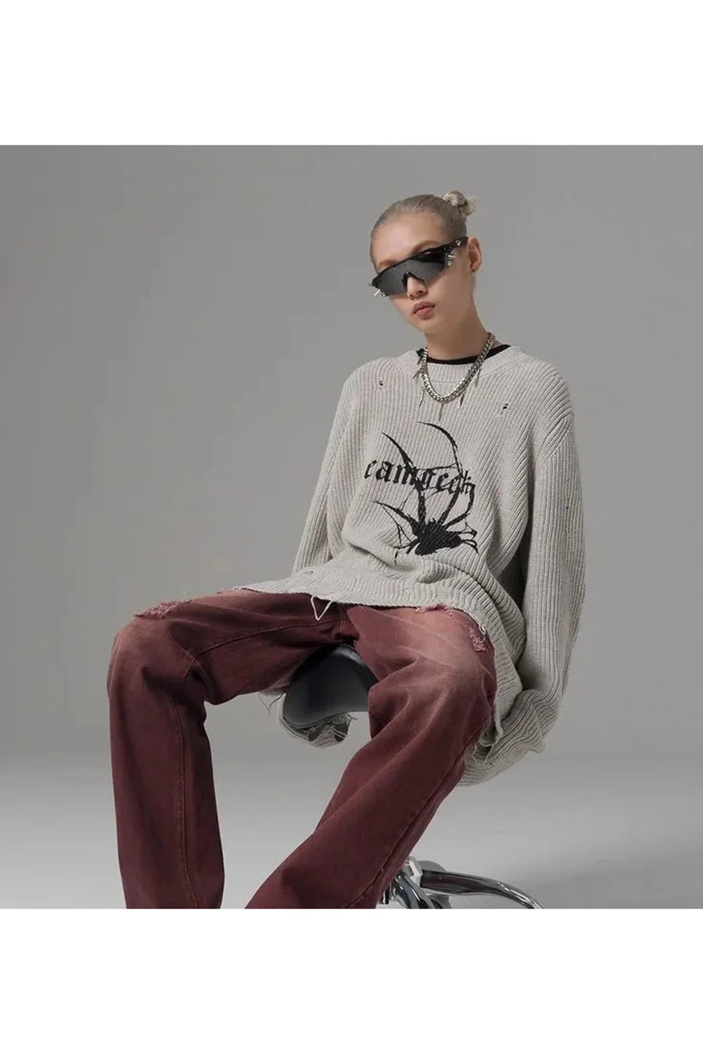 Gray Distressed Spider Graphic Sweater showcases unique design.