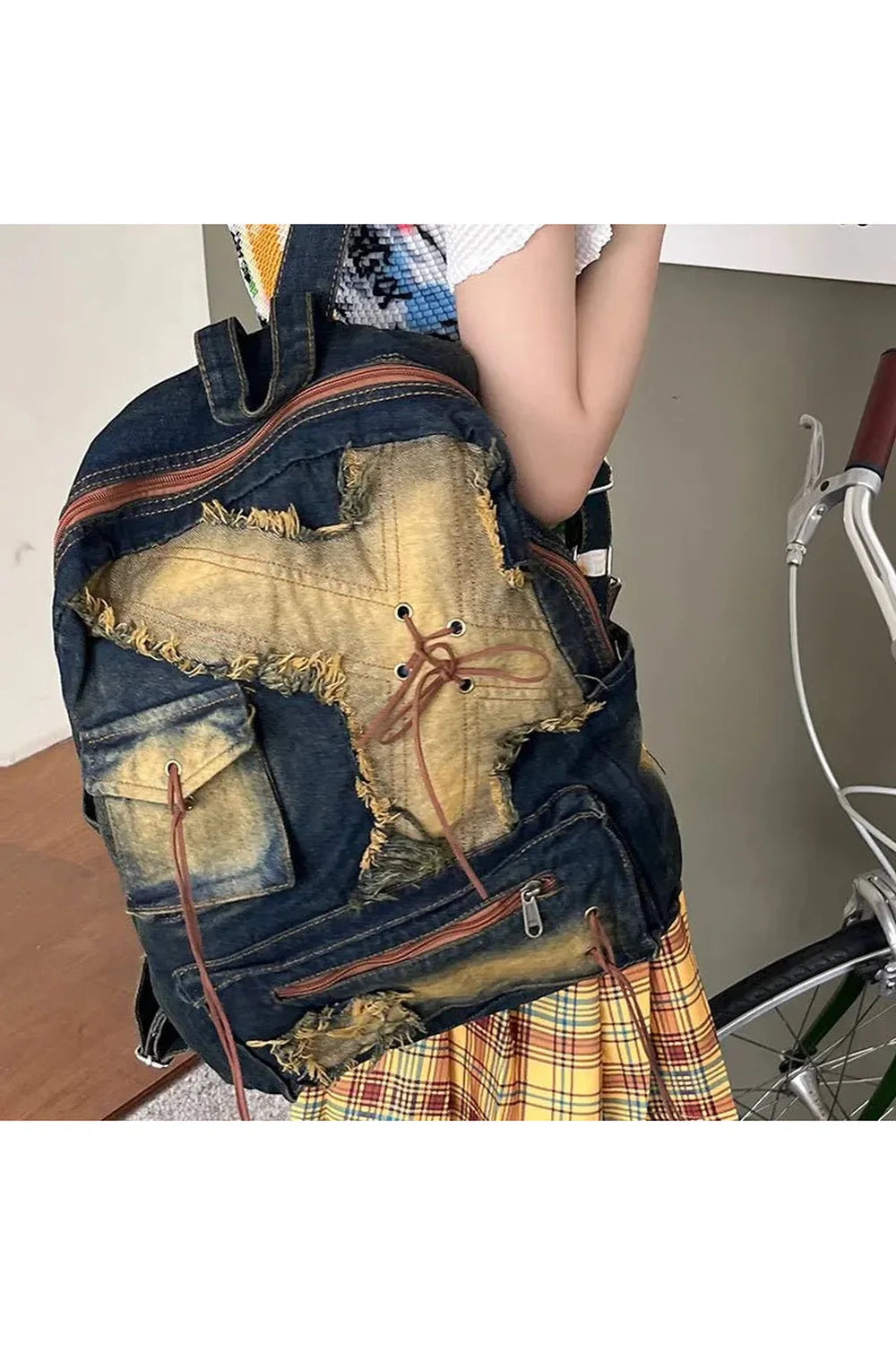 Black distressed vintage denim backpack with worn look.