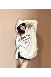 Cozy beige oversized hoodie with reverse text detail.