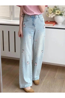 Wide-leg jeans in sky blue with floral design.