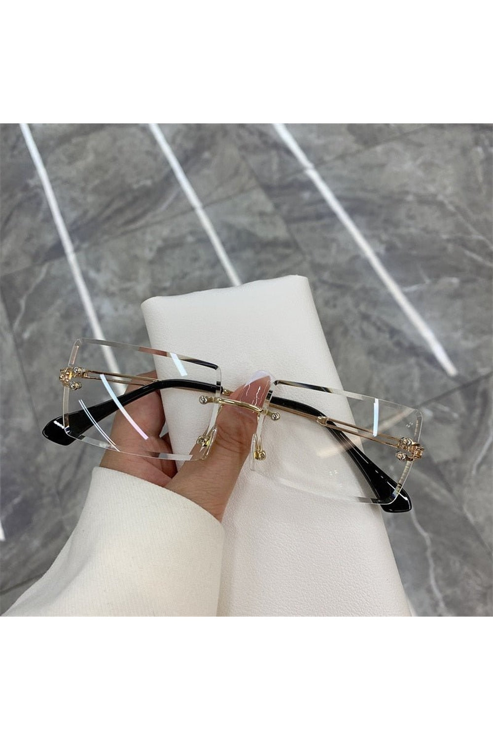 Sleek gold white frameless rectangle shades sunglasses.