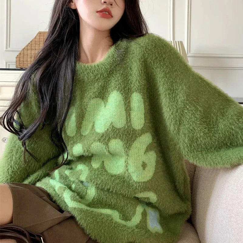 Cozy green sweater with fuzzy bear graphic.