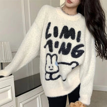 Cozy white sweater featuring fuzzy bear graphic.