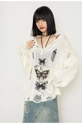 Cozy white sweater featuring a gothic butterfly motif.