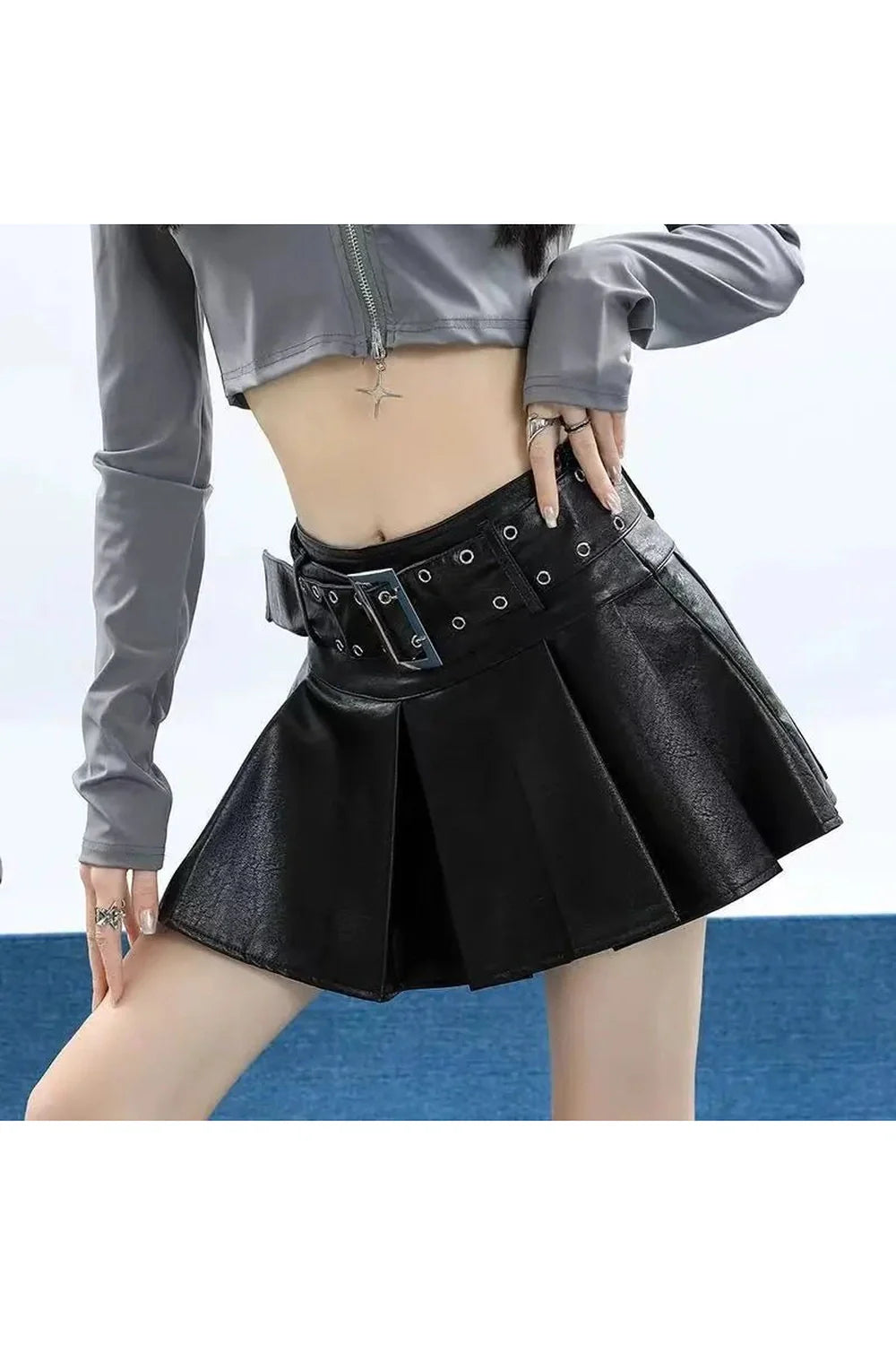 Stylish black leather skirt with grommet detail.