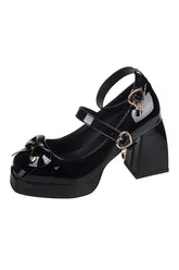 Black patent platform heels with heart charm detail.