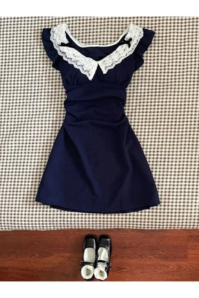 Blue lace-trimmed vintage doll dress for playtime elegance.