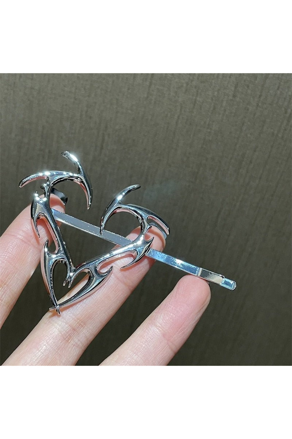 Heart-shaped metal hair clip in silver.