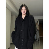 Cozy black oversized cardigan with midnight buckle detail.