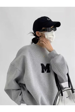 Oversized gray sweatshirt with monochrome varsity design.