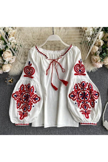 White embroidered lace-up blouse in national style.