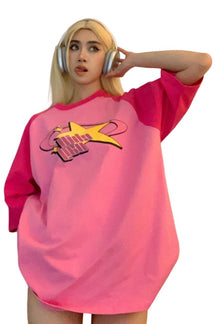 Oversized pink t-shirt with star motif.