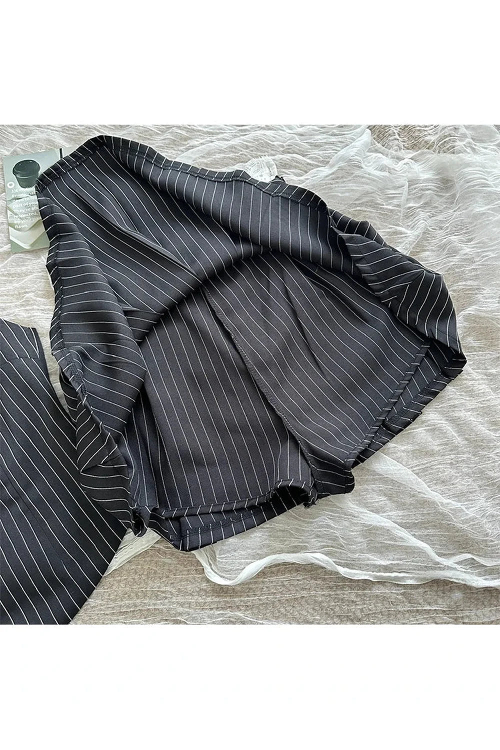 Black pinstripe vest and skirt set, sophisticated.