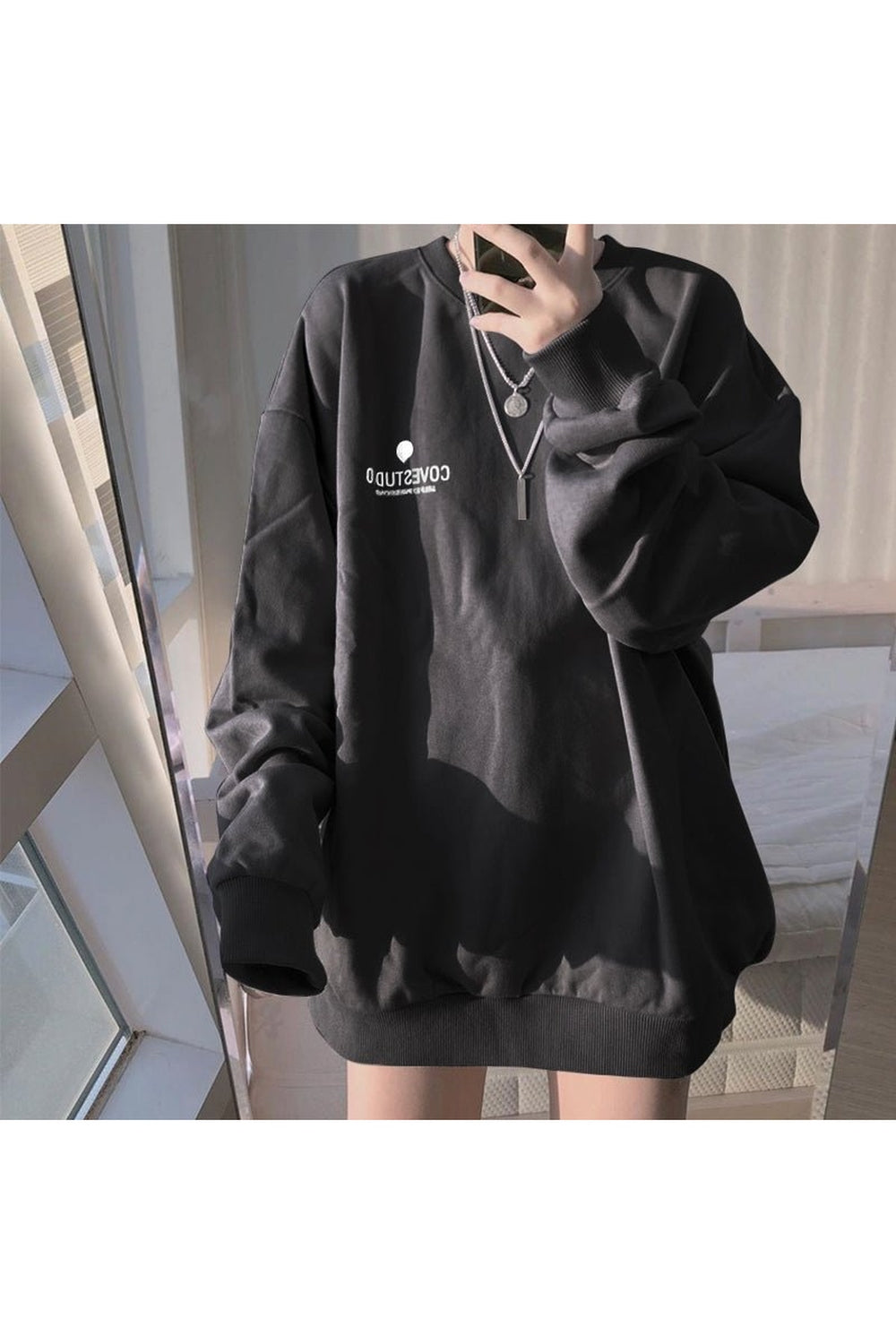 Loose pastel sweatshirt in black color aesthetic.