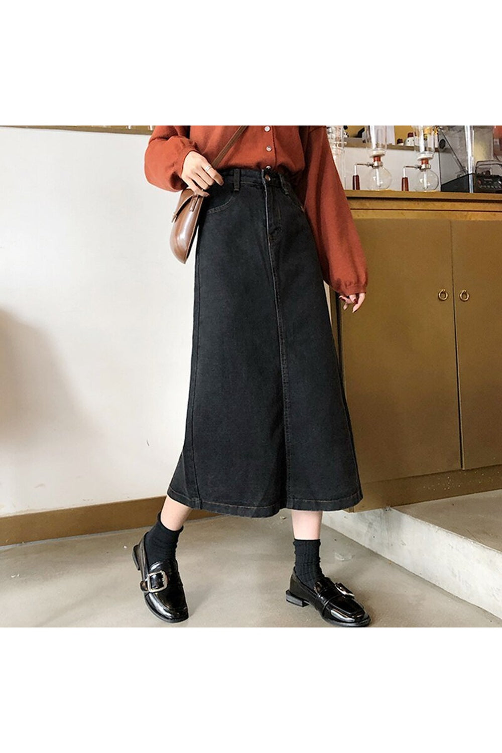 Long black denim skirt with retro fashion style.