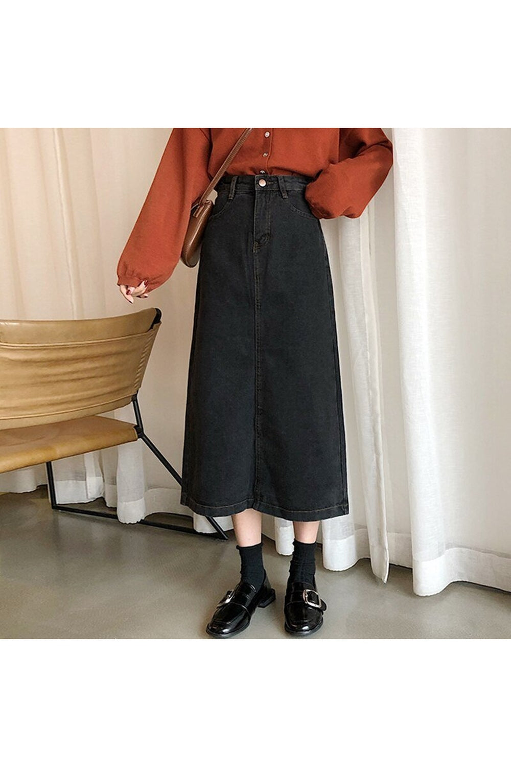 Long black denim skirt with retro fashion style.