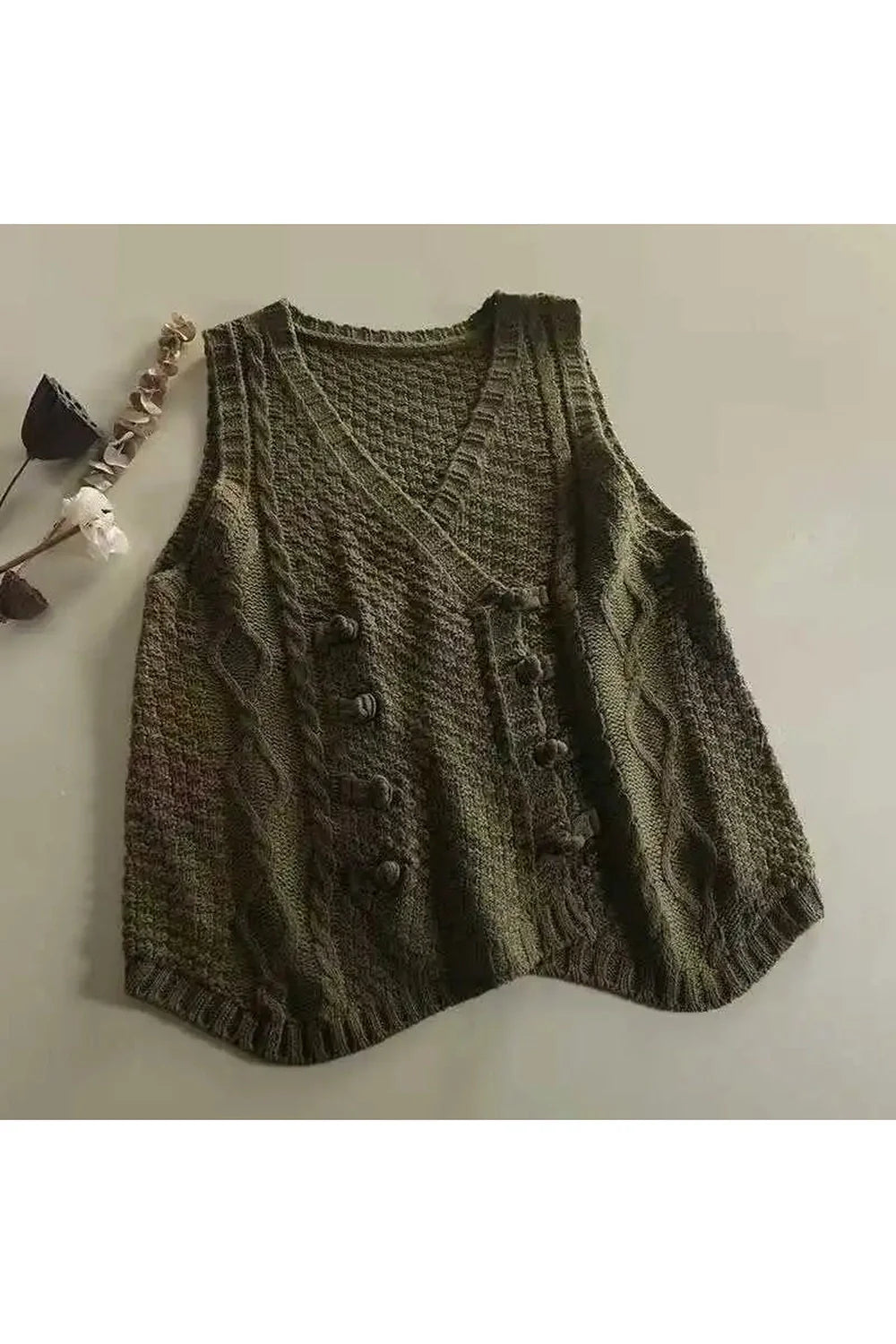 Cozy green cable knit vest for rustic charm.