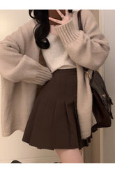 Brown-Skirts oversize cardigan set with pleated skirt.