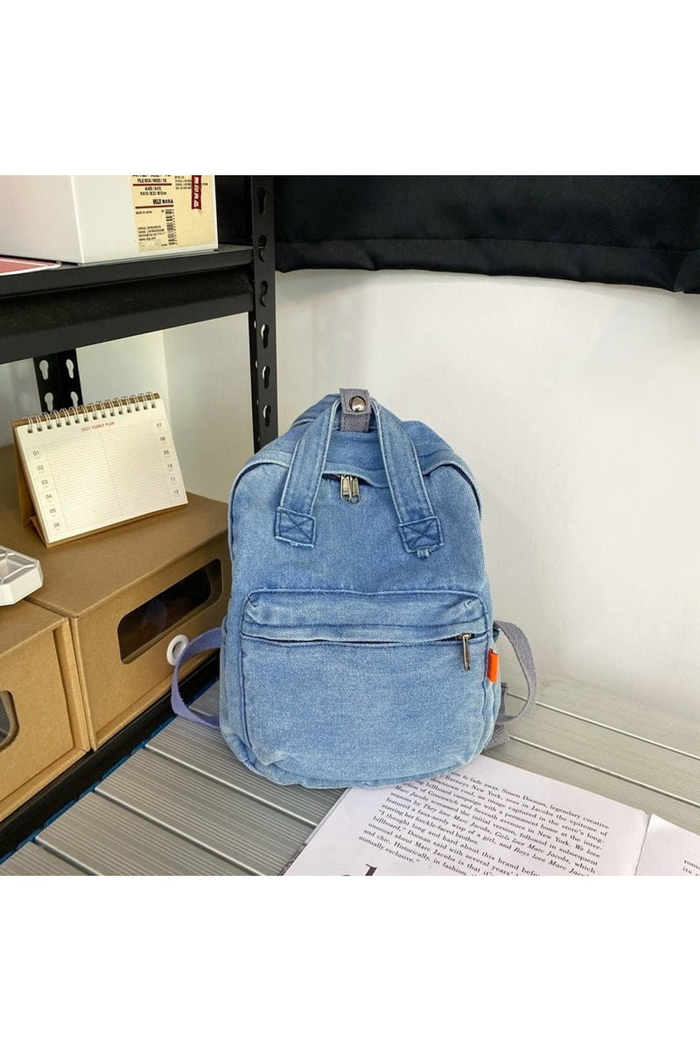 Small Denim Portable Backpack in Blue, compact design.