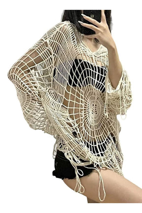 Cozy beige knit sweater with spider web design.