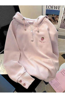 Cozy pink hoodie with embroidered strawberries for fall.