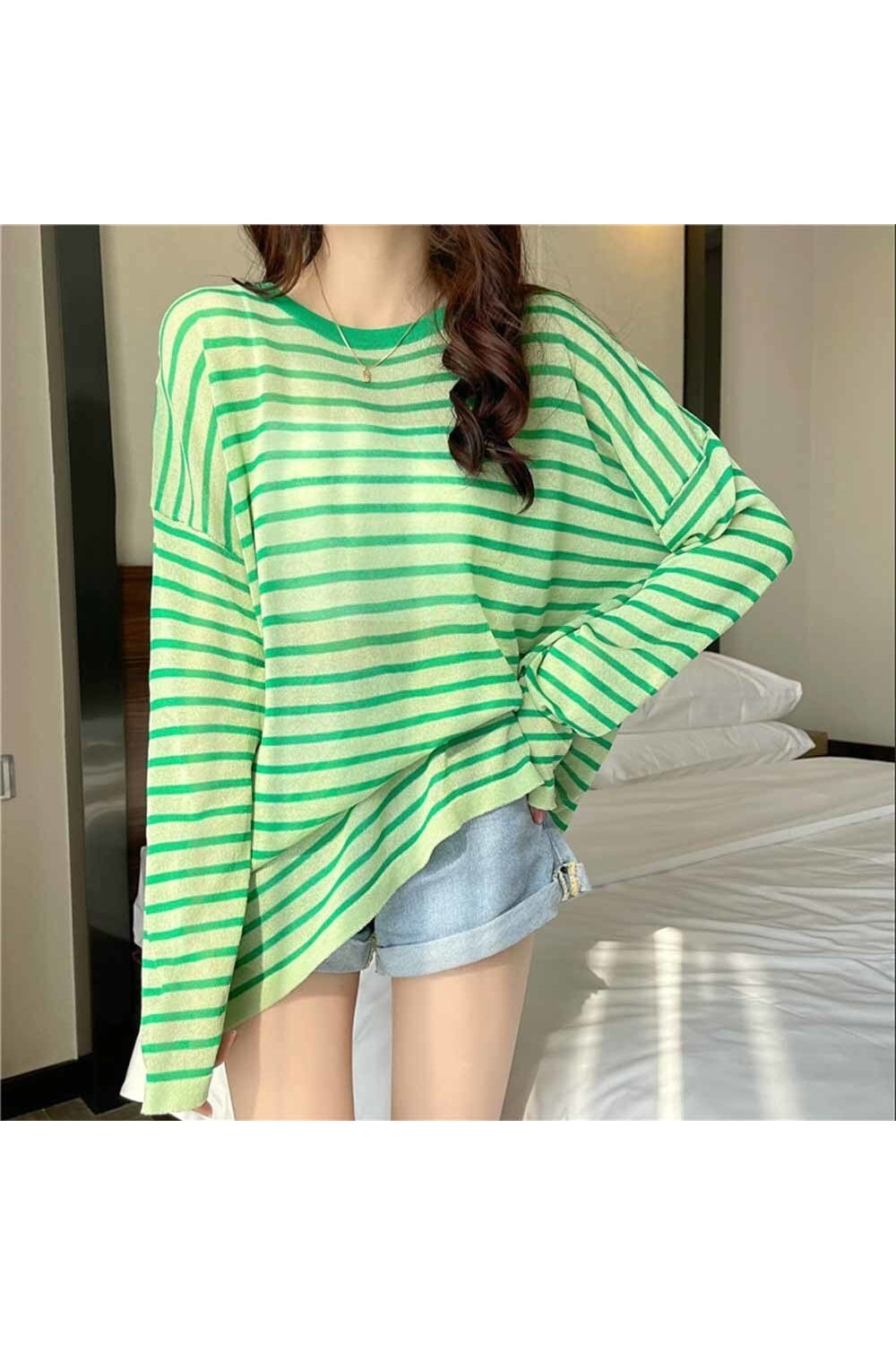 Sheer green striped tee for stylish layering.