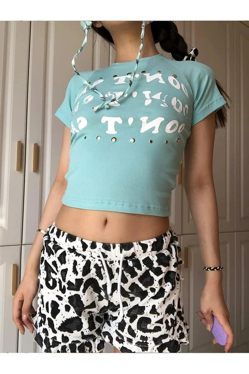 Light blue studded baby top with graphic design.