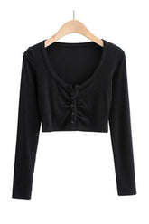 Black V-neck top: elegant long sleeves.