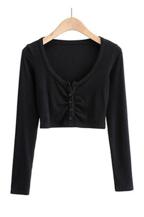 Black V-neck top: elegant long sleeves.