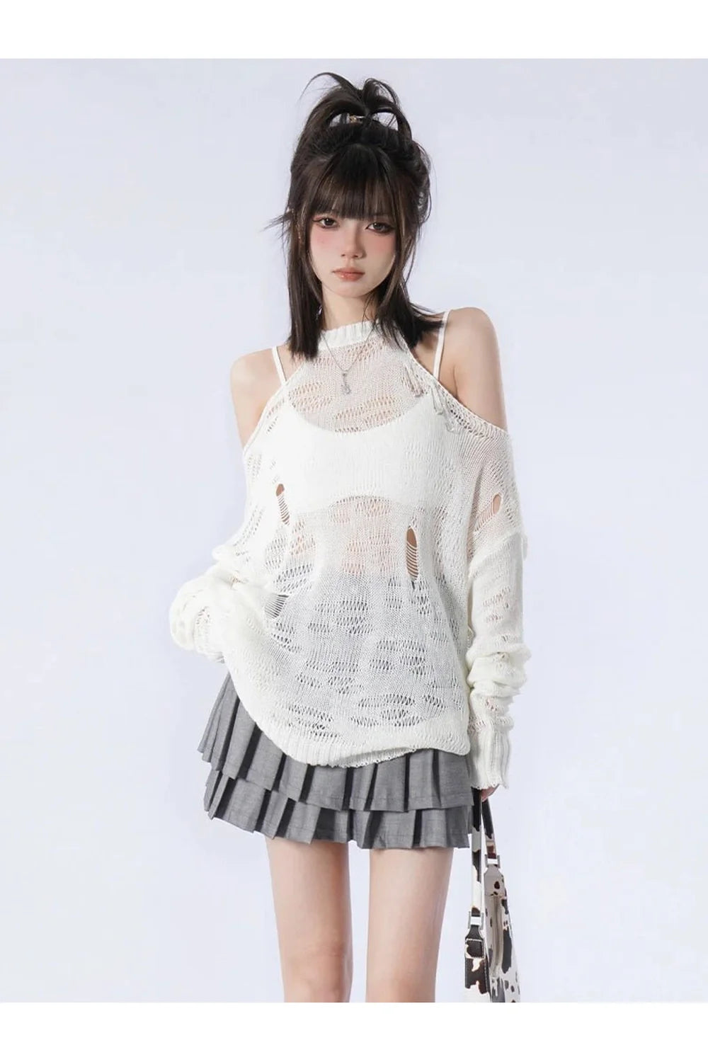 Cozy white pullover blends fairy and grunge styles.